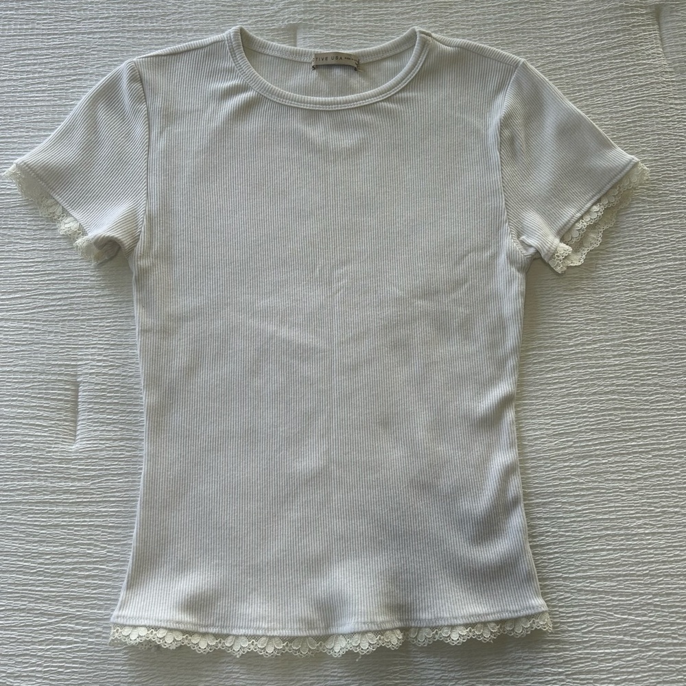 White, tight fit, short sleeve top with lace trim. Size small.